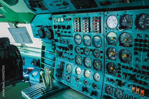 Fotografie Control panel inside a cockpt of an aircraft with various instruments and dials