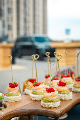Shrimp and Avocado Canapes on Wooden Board, Elegant Appetizer Close-Up