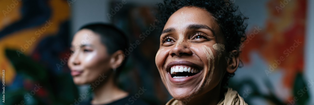 Fototapeta premium Diverse smiling women with face paint and cultural markings for artistic portrait banner background and community design