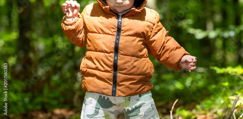 Εκτύπωση καμβά Toddler exploring forest nature with curiosity and innocence