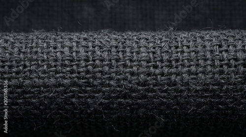 Dark abstract macro background with organic fiber grain pattern.Extreme macro shot focusing on the rich texture and natural curved fiber grain of a dark organic material with subtle lighting highlight