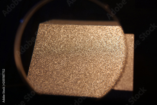 Photography Sample of aluminum under magnifying glass with small grains,that froze very fast