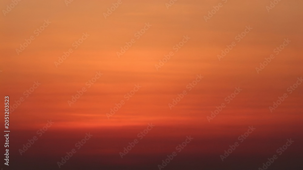 Fototapeta premium Vibrant orange and red sunset sky gradient creating a warm serene tranquil background perfect for abstract designs meditation apps peaceful nature themes breathtaking sunrise colors artistic