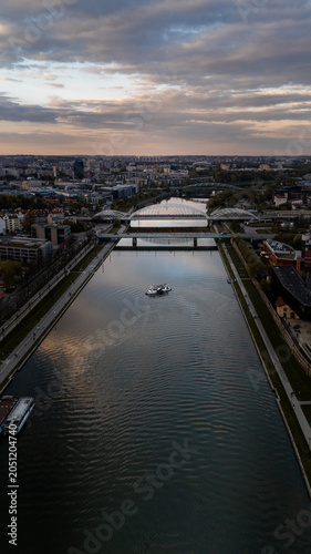 Aerial view of the Vistula River in Krakow with ships at sunset in spring, Poland