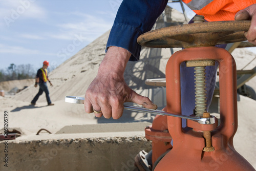 Engineer turning bolt of a valve