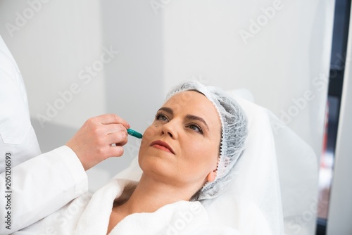 Woman receiving a cosmetic treatment in a modern clinic setting