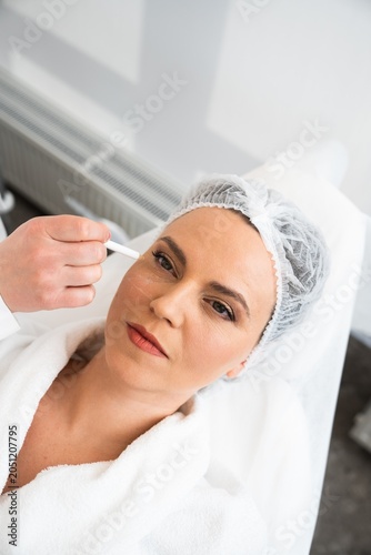 Woman receiving facial treatment at spa in cozy wellness environment
