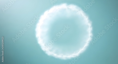 A bright white circular object on a blue background with a soft focus effect