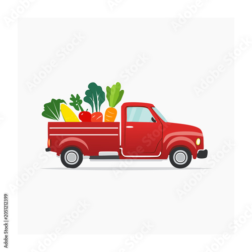 Red pickup truck loaded with fresh vegetables and fruits