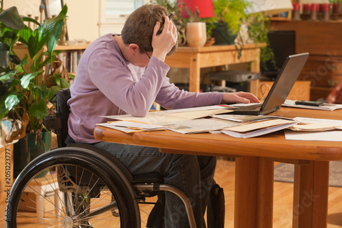 Businesswoman with multiple sclerosis concerned about her paperwork at home