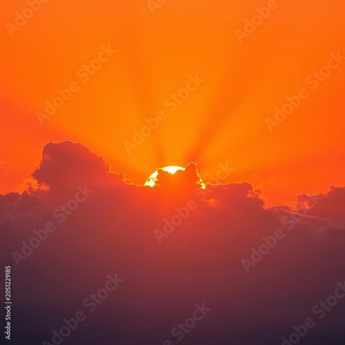 Orange sunrise with rays shining through clouds, dawn, orange