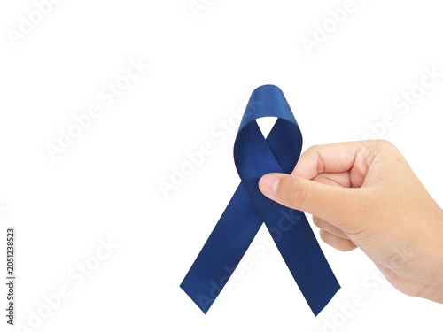 Woman holding blue ribbon for cancer awareness month. Healthcare and world cancer day concept.
