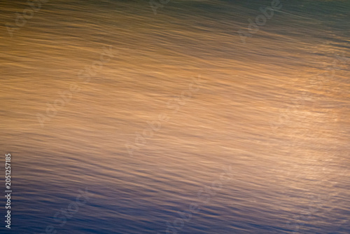 Φωτογραφία Abstract ICM intentional camera movement photograph featuring a fluid gradient from warm ochre and gold to cool slate blue, evoking a sense of rapid movement and atmospheric transition