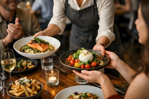 Waiter serve customers with delicious and fresh food at restaurant, people enjoy fine dining