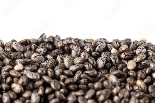 Raw of chia seeds on white background. Extreme close-up