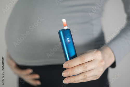 Woman smoking during pregnancy. Danger, unhealthy habit.