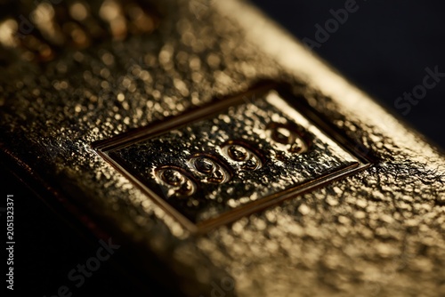 Textured gold bar showing .999 purity marking