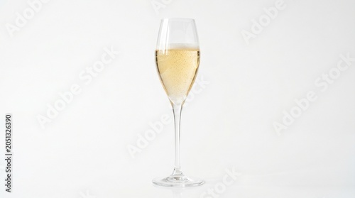 Elegant tulip-shaped champagne glass filled with bubbly sparkling wine or prosecco, isolated on a white background.