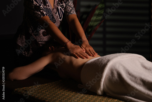 Obraz na plátně Thai Therapist performing full back massage with hands applying pressure on clie