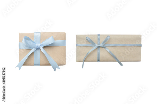 Cutout image of two naturally styled gifts decorated with blue ribbons of different widths.