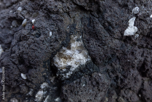 Obraz na płótnie Crystalline calcite mineral deposit embedded in a dark volcanic rock matrix feat