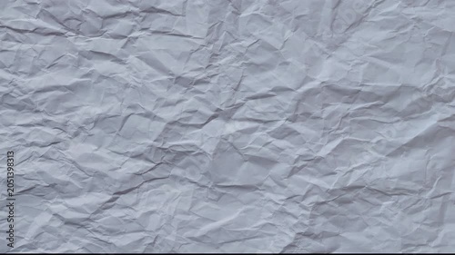 Abstract crumpled paper texture background with soft lighting. Minimal clean surface for design, presentations, typography, overlay and motion graphics.  Seamless looping 4k