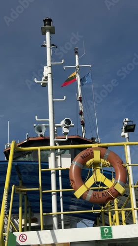 Ship mast and lifebuoy on Klaipeda harbor vessel