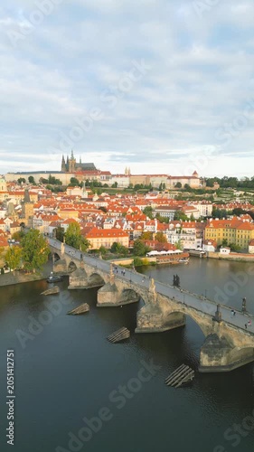 Experience a stunning aerial view of Charles Bridge and Prague Castle. This breathtaking panorama showcases the medieval architecture and vibrant colors of Prague at dawn.