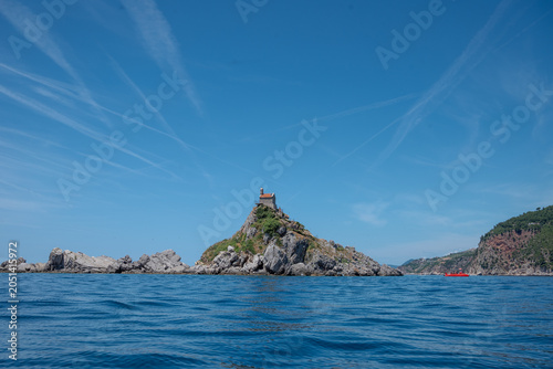 Fotografie Church of Saint Nedjelja on rocky island rising from blue Adriatic sea, Petrovac