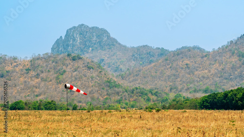 Foto Windsock indicator of wind in meadow with beautiful scenic