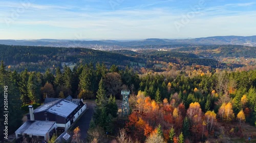 Explore the stunning views from Slovanka lookout tower in the Jizera Mountains during autumn. Experience vibrant colors and breathtaking landscapes in the forested area.
