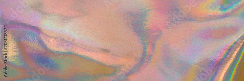 Colorful reflections appear on a surface creating a blend of hues seen in natural light