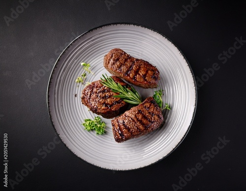 roasted bbq chuck roll beef steaks garnished with herbs black background bird s eye view