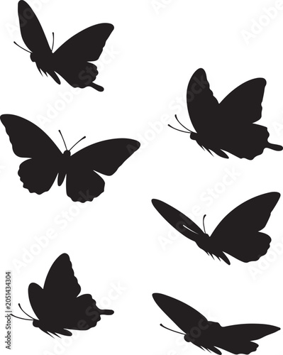 Set of black butterfly silhouettes flying isolated on a white background