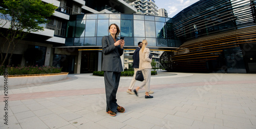 Business people walk outsid...