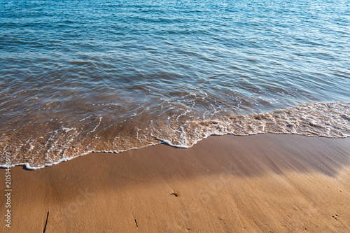 Slika na platnu Blue ocean waves gently lapping on fine sandy natural shore