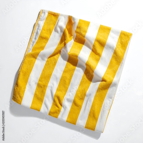 A crumpled yellow and white striped fabric on a plain surface