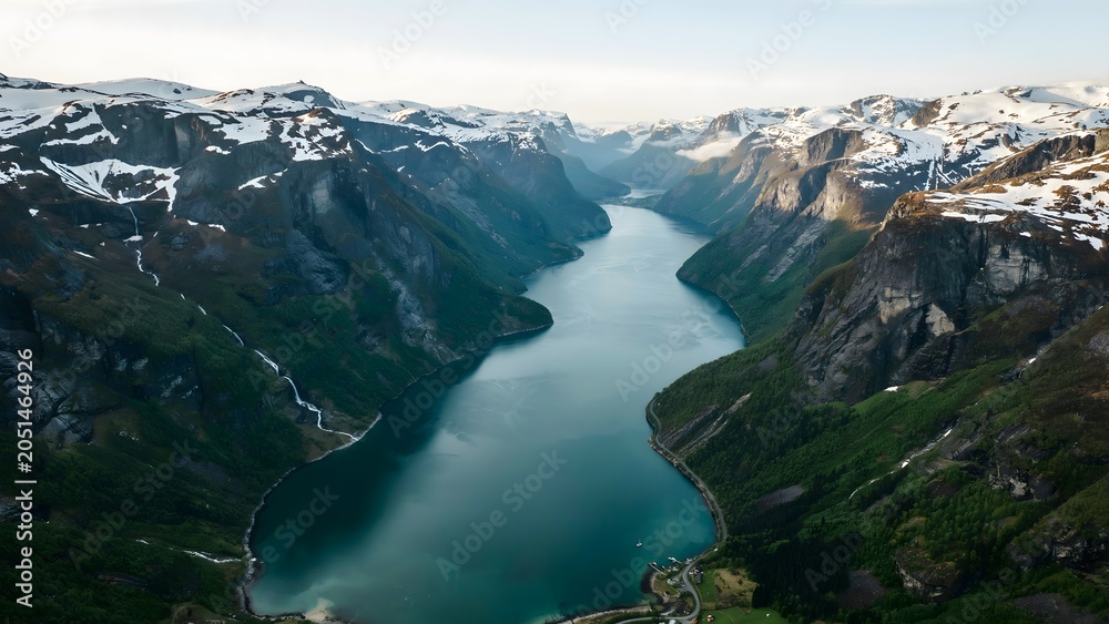 Fototapeta premium Breathtaking fjord surrounded by snow-capped mountains and lush greenery