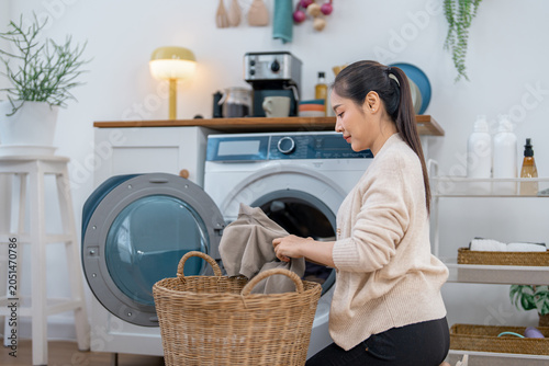 Schilderij op canvas Woman laundry washing machine basket home clothing indoor housework detergent ap