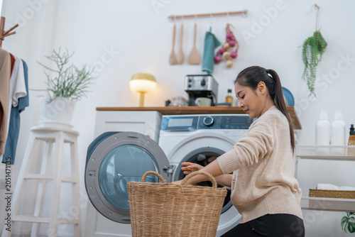 Fotografía Laundry room woman basket washing machine clothing home domestic chore clean app