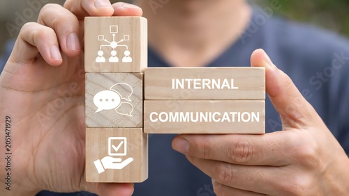 Business Professional Holding Wooden Blocks Representing Internal Communication Strategies and Effective Corporate Team Collaboration Icons