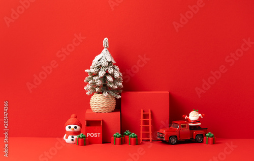 Christmas Scene with Snowy Pine Tree, Red Podium, Toy Truck, Snowman, Santa and Gifts on Red Background