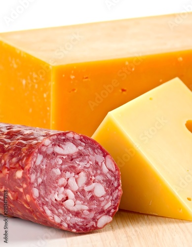 A cured meat and cheese arrangement on a wooden surface