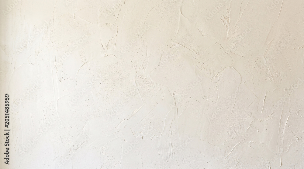 Fototapeta premium Textured plaster wall background with subtle variations in neutral cream tones