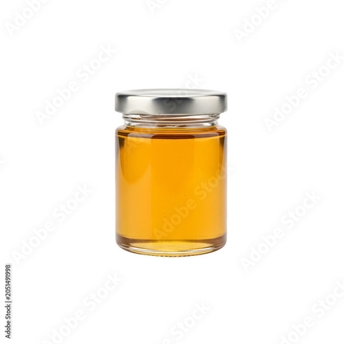 Golden honey in a clear glass jar with metal lid