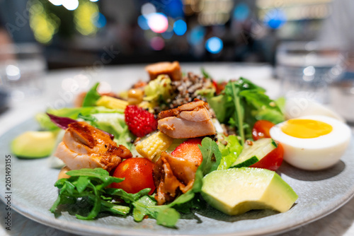 Obraz na plátne Fresh Avocado Salmon Salad with Hard-Boiled Egg, Cherry Tomatoes, and Mixed Gree