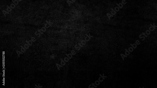 A gritty stop-motion seamless loop animation featuring textured black paper with grain, speckles, and analog imperfections. Minimal dark background for overlays, titles, and motion graphics