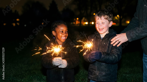 Children playing with sparklers for fourth of july america night event