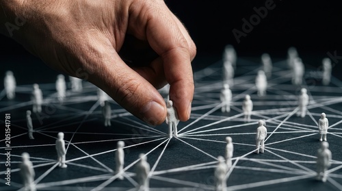 A hand placing a miniature figure to illustrate stakeholder mapping and audience engagement.