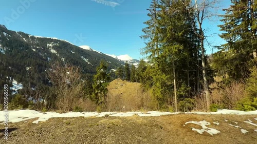 Scenic Swiss Alps Mountain Landscape with Wooden Chalets and Snow-Capped Peaks